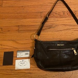 Black leather Prada shoulder bag. Includes tags to authenticate!